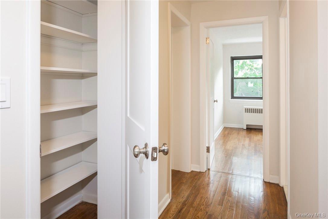 Hallway to 3 bedrooms includes spacious linen closet.