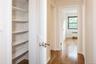 Hallway to 3 bedrooms includes spacious linen closet.