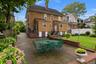 Gracious and welcoming backyard for dining, BBQing, and gardening