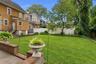 Gracious and welcoming backyard for dining, BBQing, and gardening