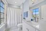 Marble vanity and stunning custom marble tile work throughout