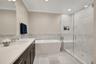 Beautiful marble tile work and spa features in large glass shower