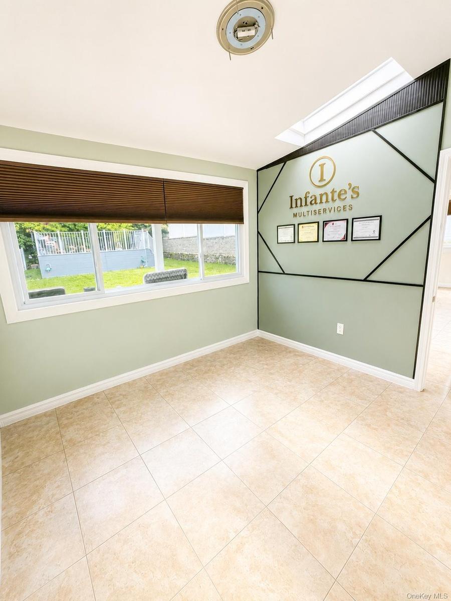 Tile flooring, multiple windows, window blinds, and a skylight