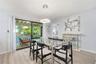 Spacious Dining Area adjacent to Large Sliders, Lanai, and Lush Landscaping.