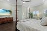 The primary suite is adorned with plantation shutters and recessed lighting