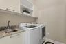 The laundry room is located on the first floor, just off the bonus room