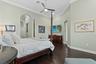 The hallway leading into the primarty suite features two walk-in closets