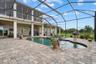 This view shows the upper lanai, and the lounge off the family room.  The door shown leads to a half bath