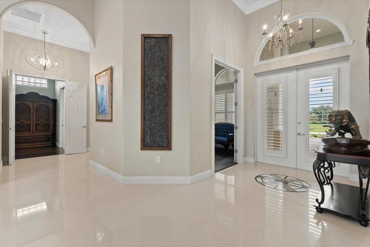 Looking back towards the front entry, door to the study and french doors entry to the primary suite