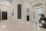 Looking back towards the front entry, door to the study and french doors entry to the primary suite