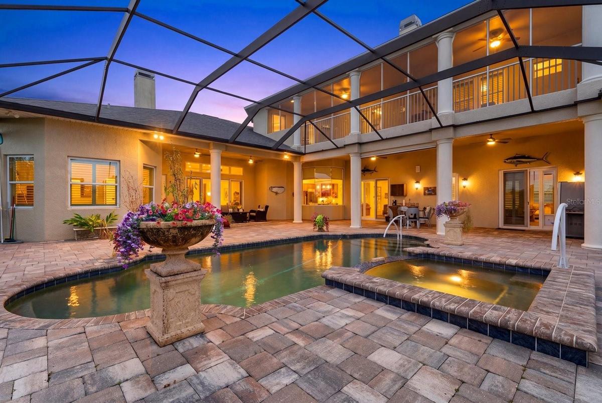 The pool deck offers two separate lounge areas surrounding the pool and spa, as well an expansive upper lanai