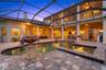 The pool deck offers two separate lounge areas surrounding the pool and spa, as well an expansive upper lanai