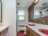 2nd floor: Bathroom with double red sinks, red tile floor with a built-in vanity.