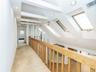 2nd floor: open hallway/balcony.  4 skylights. Carpeted floors.