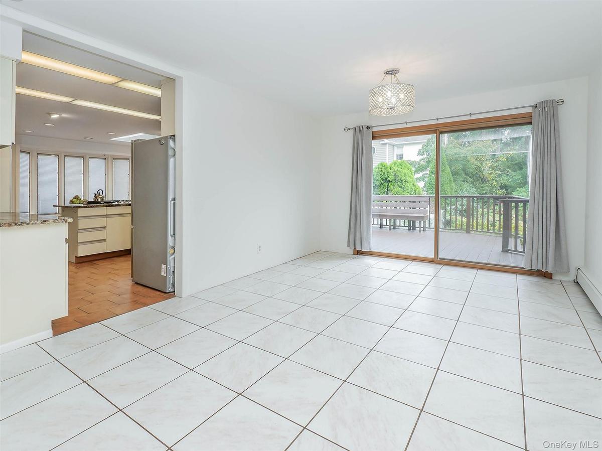 Dining room with sliding glass doors out to the deck. Great for bringing the party outside!
