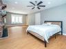 1st floor: Primary bedroom with en suite bathroom. Ceiling fan