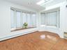 Window seat on one of the bay windows. Room for your kitchen table. Skylight above.