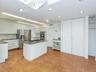 The is a pantry behind the double white doors.  Plenty of storage in this kitchen.
