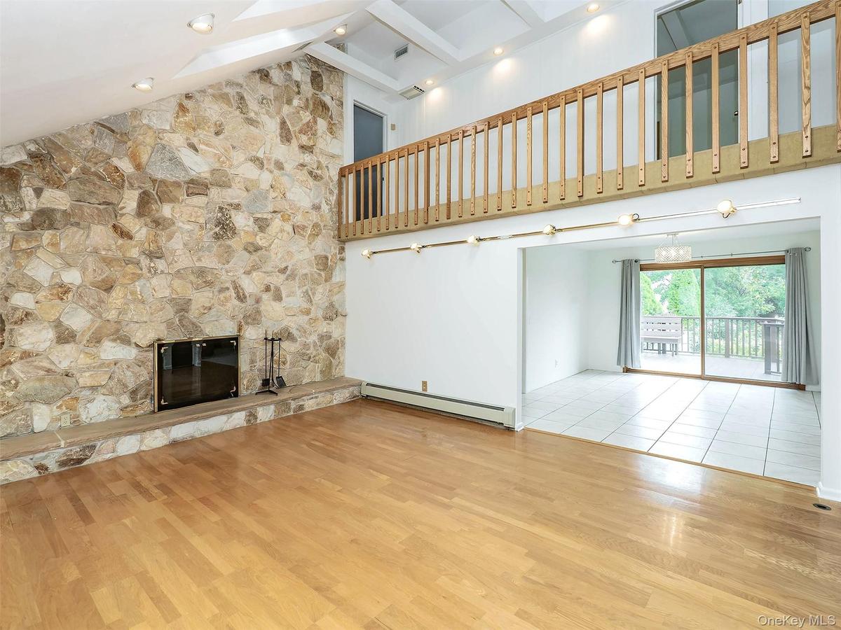 Living room is open to the dining room with sliding doors to the backyard deck