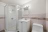 A full bathroom on the lower level adds another layer of convenience, complete with a walk-in shower.