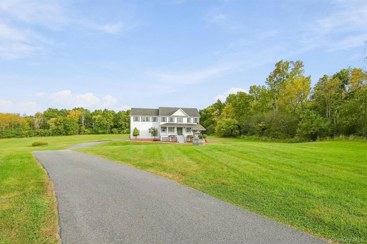 A long, sweeping driveway creates an impressive approach while setting the home comfortably back from the road.