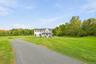 A long, sweeping driveway creates an impressive approach while setting the home comfortably back from the road.
