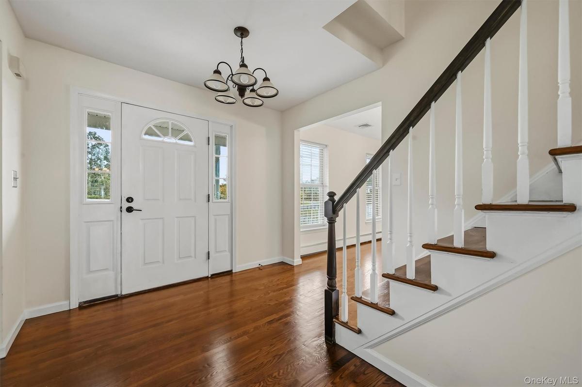 Hardwood floors and an open staircase set the tone as soon as you walk through the door.
