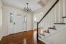 Hardwood floors and an open staircase set the tone as soon as you walk through the door.