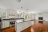 Recently updated kitchen featuring refreshed cabinetry, countertops, stainless steel appliances, and a large center island.