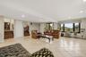 Spacious 1st level recreation room with large windows, recessed lighting, and light-toned tile flooring