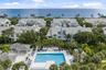 Community pool, spa, and outdoor lounge area with bbq, covered bar, and seating area
