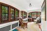 4-Season Sun Room with wall of arched windows and doorway.