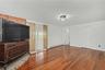Huge family room with bricked platform for woodburning stove and glass sliders to backyard