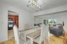 Cheerful dining room with open floor plan to living room