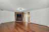 Huge family room with bricked platform for woodburning stove and glass sliders to backyard