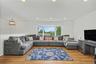 Spacious living room with a large bay window for great natural light and wood flooring