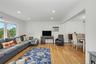 Spacious living room with a large bay window for great natural light and wood flooring