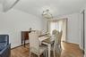 Cheerful dining room featuring wood flooring and sliding glass doors to deck over looking large and level back yard