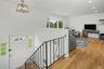 Inviting entranceway leads to living room with wonderful natural light, wood flooring and subtle recessed lighting