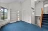 View from the den/family room, a few steps lead down to the kitchen, with a laundry area upstairs