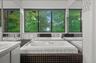 View looking out to wall-to-wall windows and a spa tub