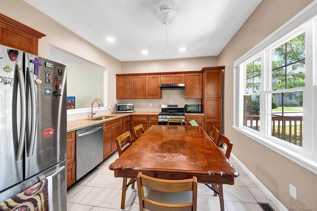 Large eat-in kitchen with hardwood cabinets, granite counter tops and stainless steel appliances