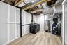Utility room with forced air heating and cooling system and washer/dryer units