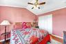 Large second bedroom with high ceilings, big windows and hardwood floors