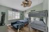 Bedroom #4 on the front of this home is set up as a bunk room and has cathedral ceiling and lots of natural light pouring in.