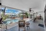 This backyard porch is raised up 2 steps from the pool deck.
