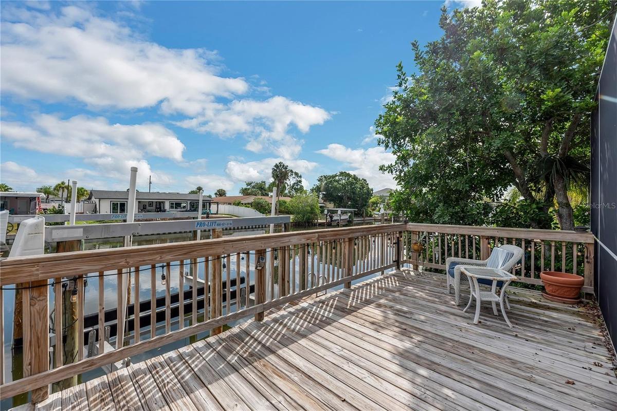Boating enthusiasts will appreciate two private docks with boat lifts and a wood deck overlooking the canal.