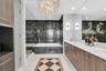Modern ensuite bath with stone finishes.