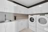 Dedicated laundry room with built-in cabinets.