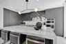 Gourmet kitchen 3" mitered Taj mahal countertops with waterfall on both edges of the island.
